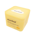 Top view of yellow cube-shaped box. White cloud-shaped print on lid with dearcloud logo.