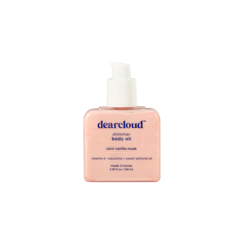 Square bottle of dearcloud Shimmer Body Oil with a pink cloud-shaped cap.   White pump.