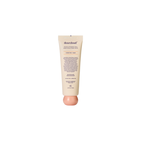 Tube of dearcloud hand cream, showing brand name and some text. Tube is light pastel cream with a pastel orange spherical twist off cap.
