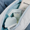 dearcloud skincare Value Set image that includes cleanser, sunscreen, and moisturizer in a blue makeup bag. 