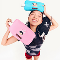 Model smiling, holding three cosmetics bags: Skurvy Black, Julius Teal, and Bunny Girl Pink.