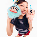 Model holding Paul Frank Julius Loofahs. Peach and Aqua teal colors.