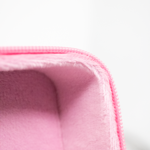 Close up of cosmetics bag including inner-lining and zipper detail.