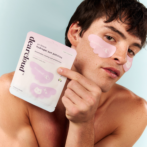 Male model wearing pink patches shaped as wings with white logo, sparkles, and cloud printed in the center.