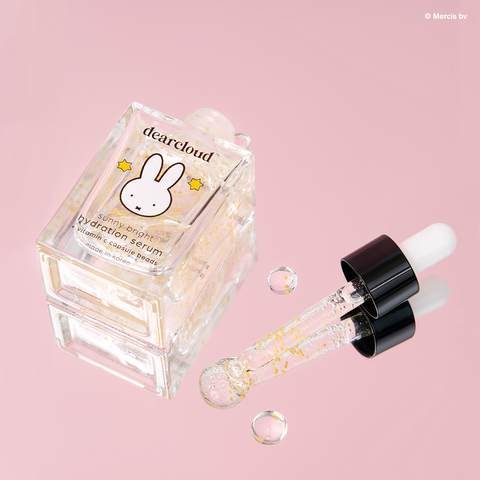 dearcloud Miffy clear serum with yellow vitamin c infused beads, on a pink background.