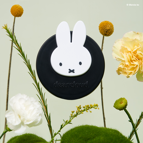 Black circle compact with white Miffy head and "dearcloud" logo embossed in black. 