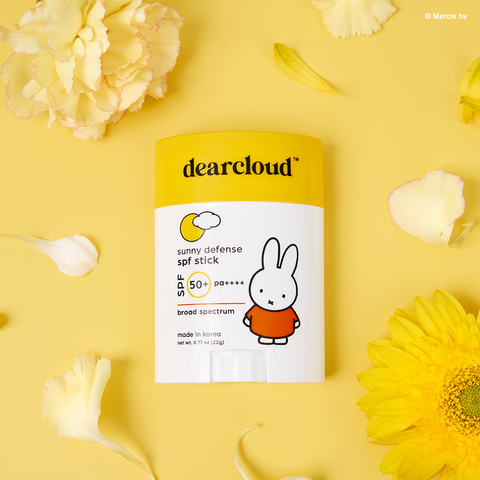 Miffy Sunny Defense Sun Stick SPF 50+ PA++++. Yellow cap with "dearcloud" logo. White packaging with Miffy character in orange dress. 