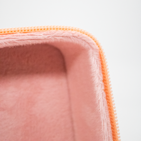 Close up of cosmetics bag including inner-lining and zipper detail.